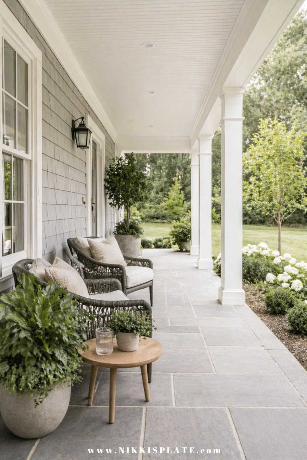 front porch planter ideas with green ferns and neutral pots on a modern farmhouse porch
