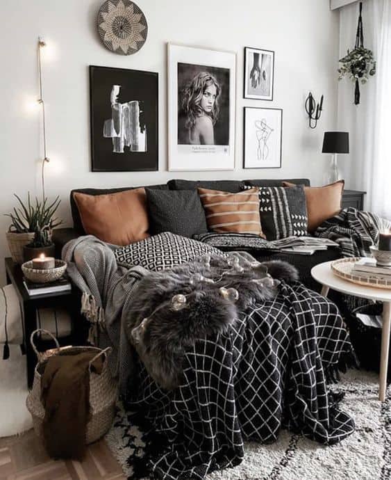 20 Beautiful Black Couch Living Room Ideas; black sofas in bohemian living rooms with wall photo gallery and throw blankets
