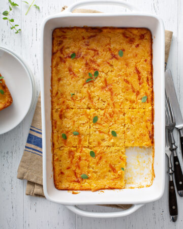 Easy Cheesy Cornbread Casserole Recipe; a delicious comforting side dish for thanksgiving, Christmas or any holiday! Made with cornmeal and cheddar cheese!