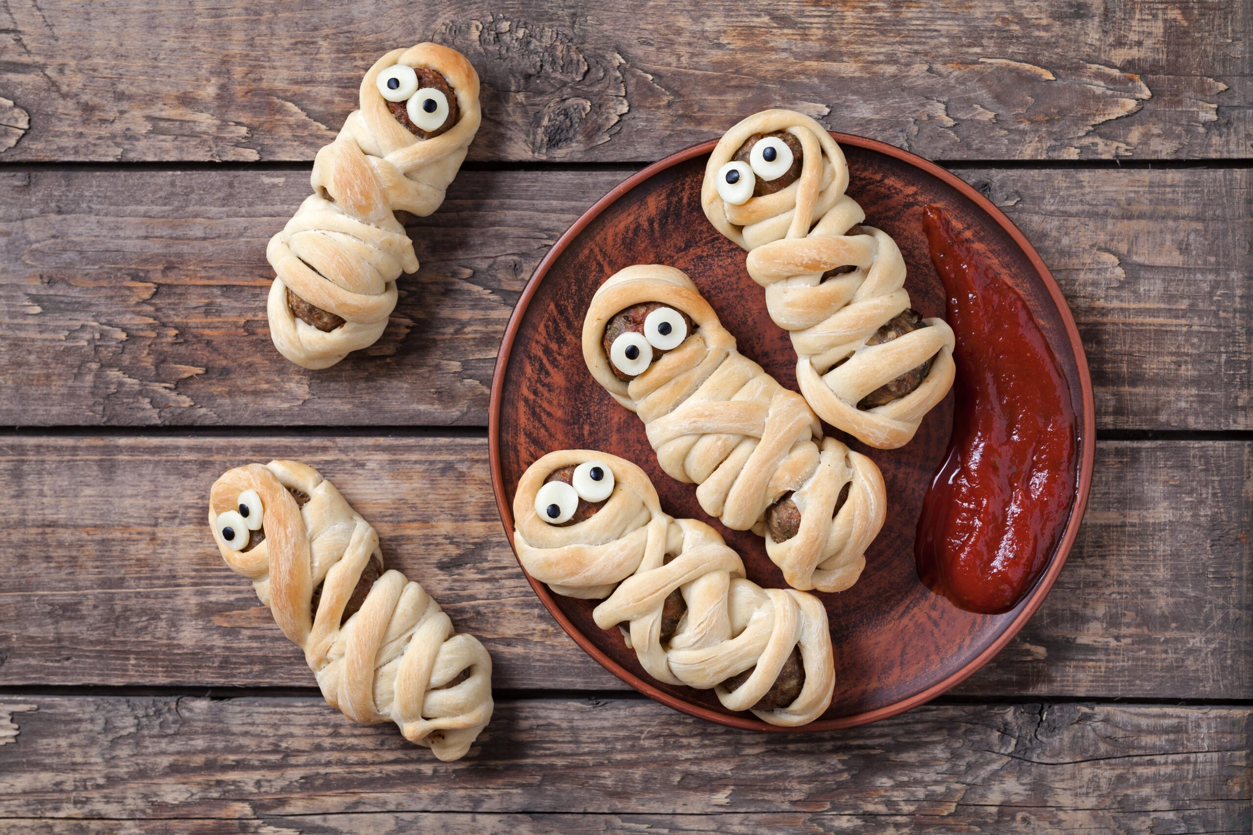 Easy Halloween Hot Dog Mummy Recipe; two ingredient mummy dogs using crescent dough and hot dogs. Easy fun Halloween recipe for kids!