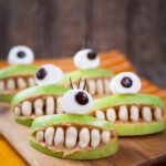 Halloween Apple and Peanut Butter Monster Mouths Recipe; simple healthy Halloween snack for kids using apples, peanut butter, peanuts, marshmallows and chocolate chips.