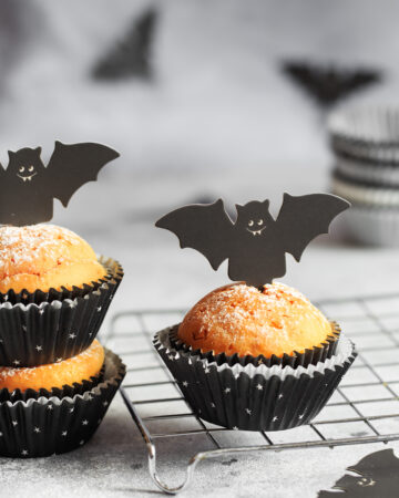 Halloween Bat Pumpkin Muffins; a cute festive halloween muffin recipe with cardboard bat top. Spooky halloween muffins!
