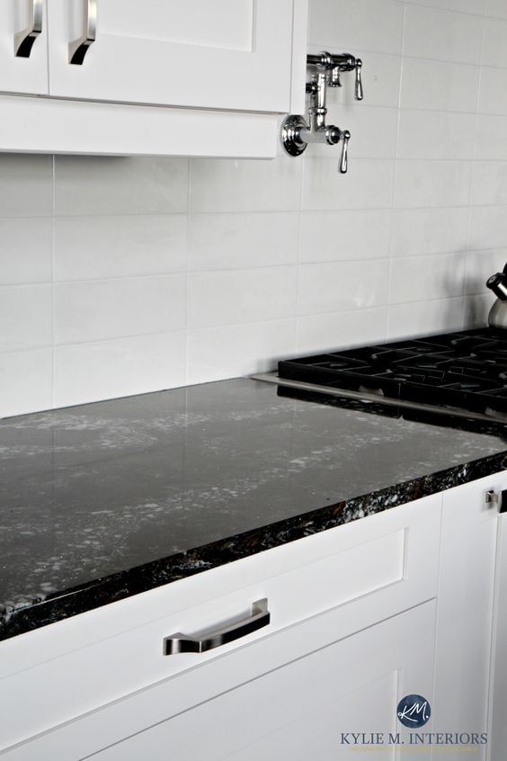 Black and white small kitchen ideas, with black quartz countertops,