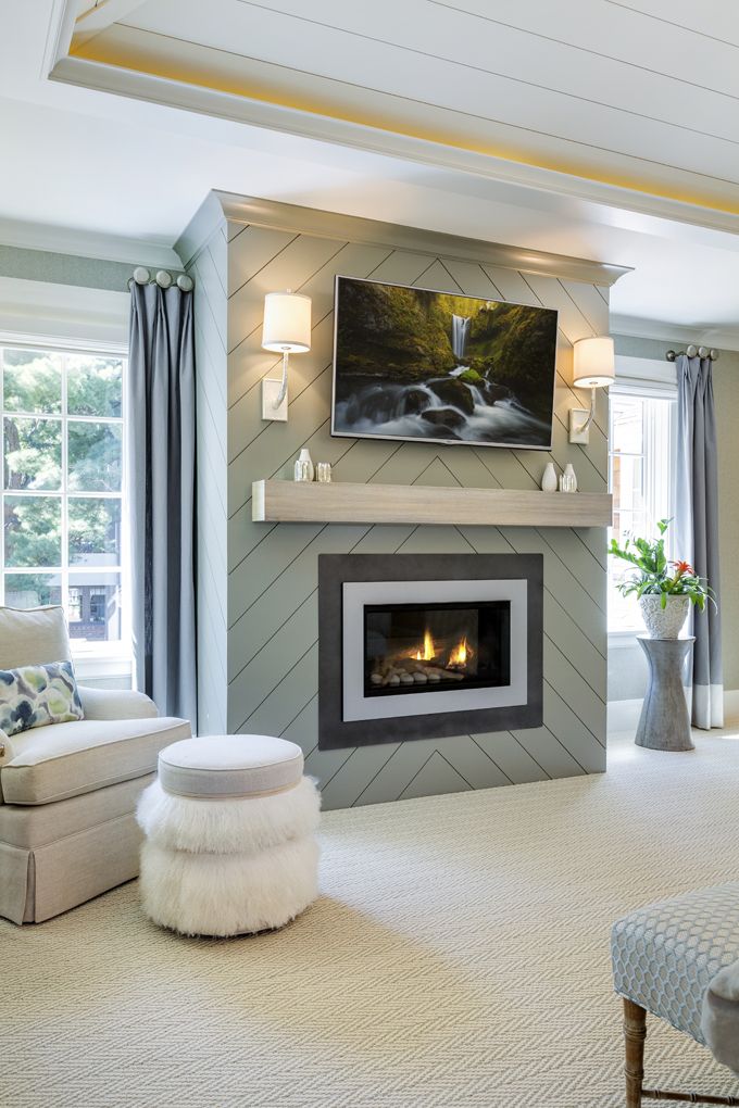 Green shiplap on fireplace with gas fireplace insert and TV