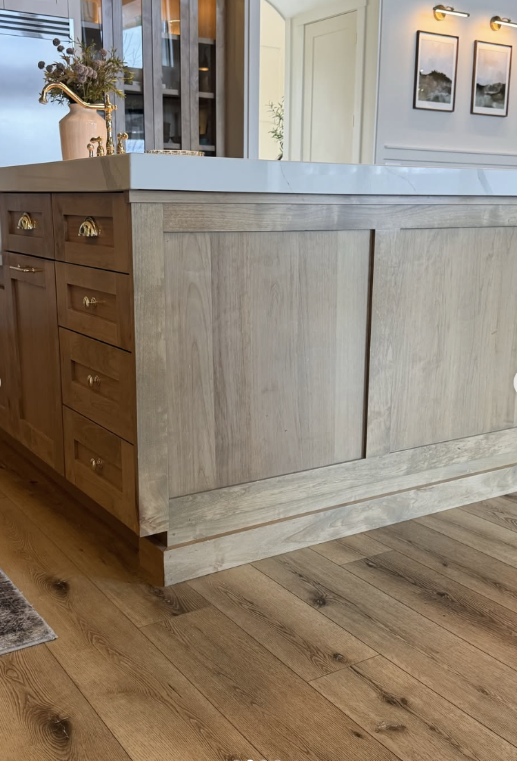 This warm-toned wood flooring adds the perfect balance of coziness and contrast to this modern farmhouse kitchen. Paired with mixed cabinetry and soft neutral finishes, it creates a grounded, inviting space that feels both elevated and lived-in. It's a great example of how medium wood tones can bring warmth without feeling too dark or heavy.