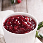 Cranberry sauce in ceramic ramekin on a napkin