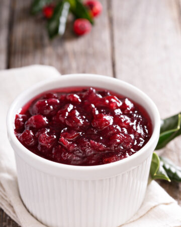 Cranberry sauce in ceramic ramekin on a napkin