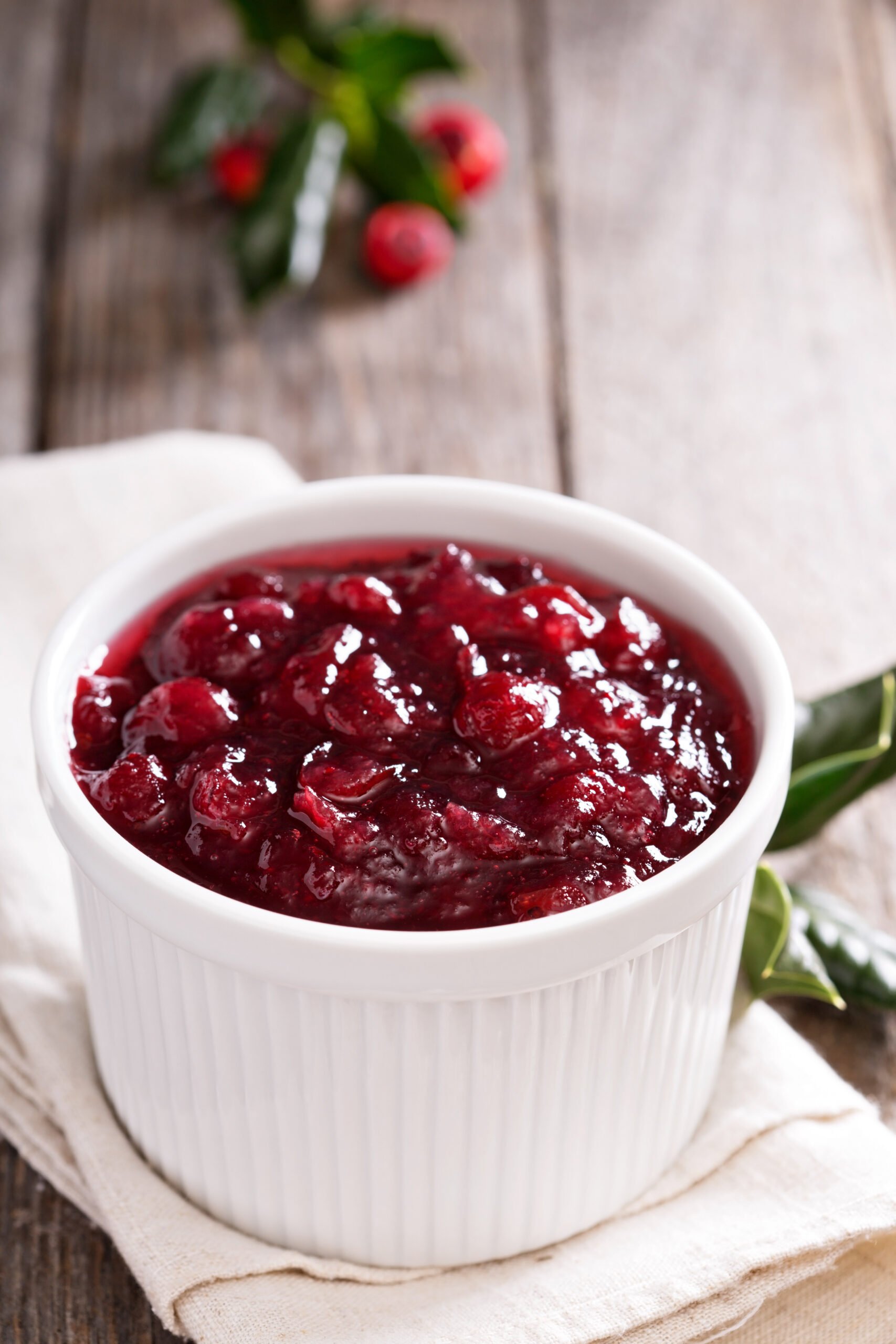 Cranberry sauce in ceramic ramekin on a napkin