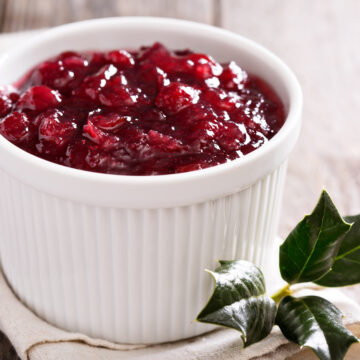 Cranberry sauce in ceramic ramekin on a napkin