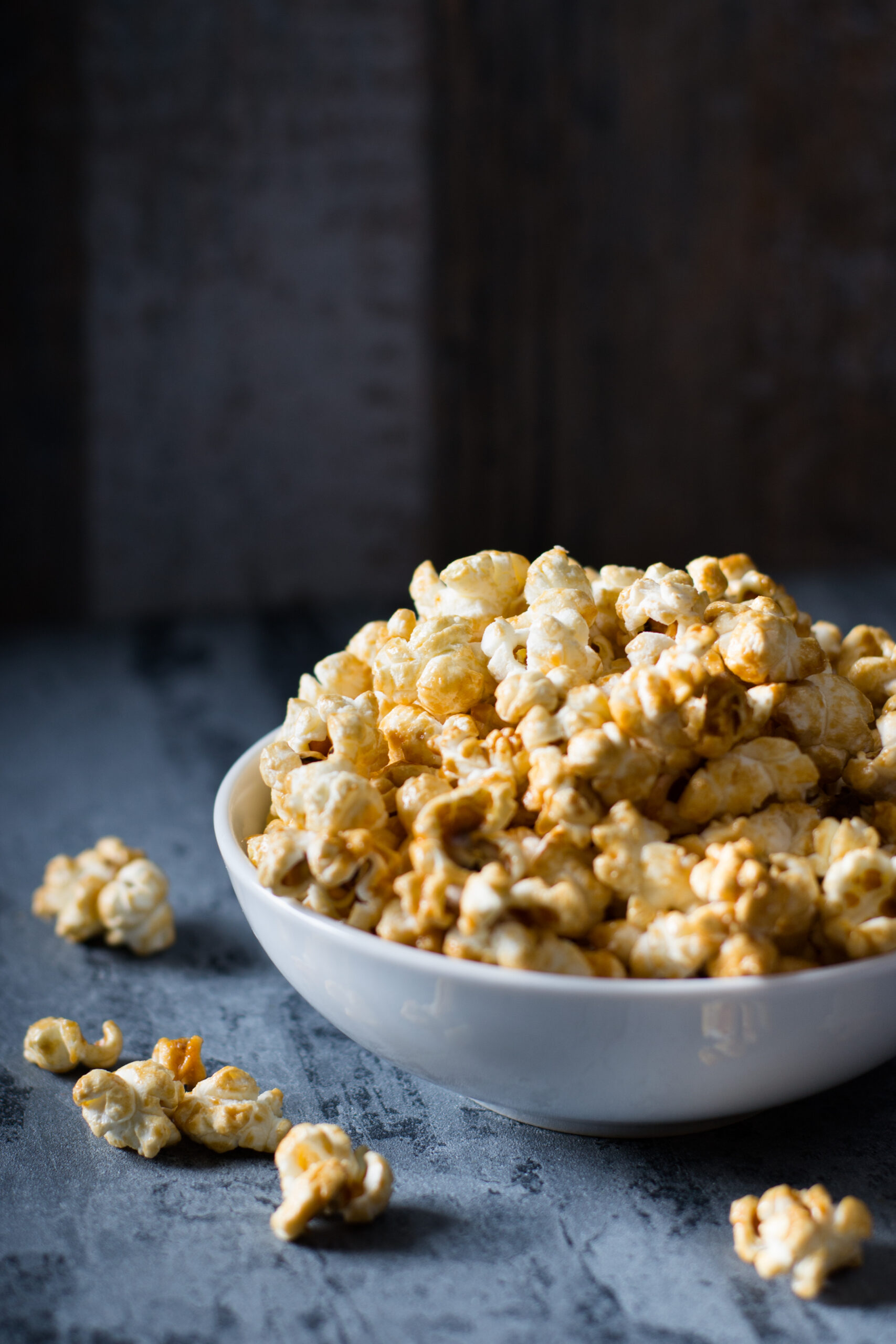 Homemade Golden Caramel Popcorn in a Bowl - Chewy Caramel Coated Popcorn Recipe; a chewy gooey version of caramel popcorn! Packed into pretty decorative bags, makes a great gift for family and coworkers!