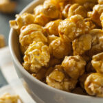 Homemade Golden Caramel Popcorn in a Bowl - Chewy Caramel Coated Popcorn Recipe; a chewy gooey version of caramel popcorn! Packed into pretty decorative bags, makes a great gift for family and coworkers!