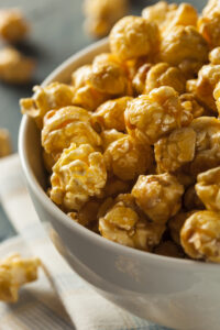 Homemade Golden Caramel Popcorn in a Bowl - Chewy Caramel Coated Popcorn Recipe; a chewy gooey version of caramel popcorn! Packed into pretty decorative bags, makes a great gift for family and coworkers!