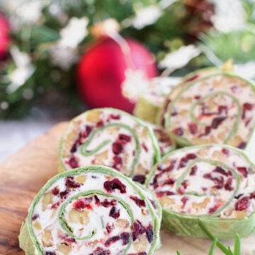 These Cranberry Walnut Pinwheels are the perfect make ahead Christmas appetizer or snack. Sweet feeling with dried cranberries, with the crunch of walnuts all mixed in a creamy filling!