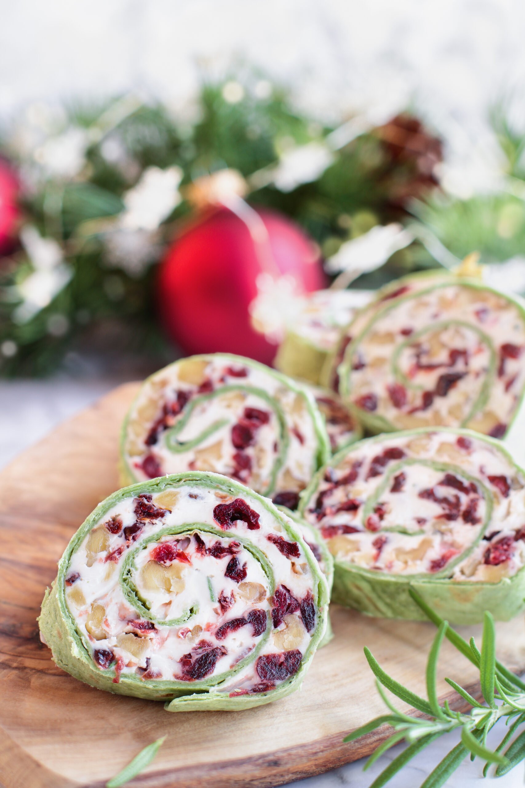 These Cranberry Walnut Pinwheels are the perfect make ahead Christmas appetizer or snack. Sweet feeling with dried cranberries, with the crunch of walnuts all mixed in a creamy filling!