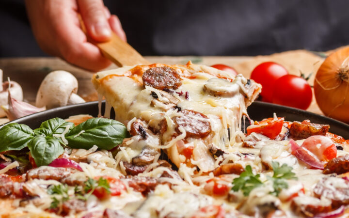 Must Try Food When on Vacation in Italy: Supreme homemade pizza lifted slice