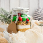 Homemade gift idea; cookie mix in a jar! A mason jar filled with pre-measured dry ingredients for delicious and festive Christmas cookies! Cookies mix with color candies in a jar. Handmade Christmas gift. Great gift or stocking stuffer!