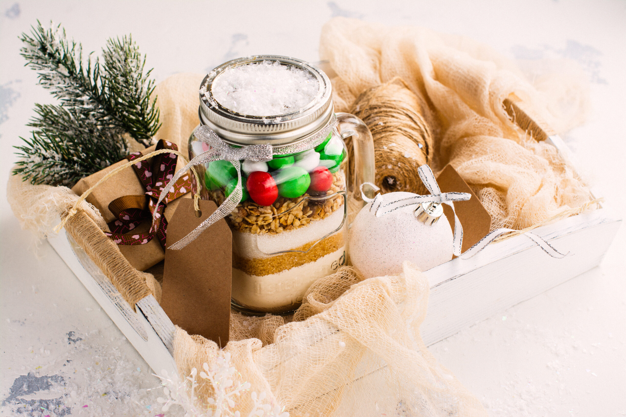 Homemade gift idea; cookie mix in a jar! A mason jar filled with pre-measured dry ingredients for delicious and festive Christmas cookies! Cookies mix with color candies in a jar. Handmade Christmas gift.  Great gift or stocking stuffer!