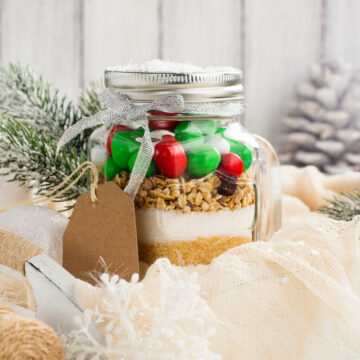 Homemade gift idea; cookie mix in a jar! A mason jar filled with pre-measured dry ingredients for delicious and festive Christmas cookies! Cookies mix with color candies in a jar. Handmade Christmas gift. Great gift or stocking stuffer!