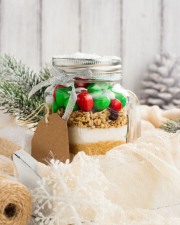 Homemade gift idea; cookie mix in a jar! A mason jar filled with pre-measured dry ingredients for delicious and festive Christmas cookies! Cookies mix with color candies in a jar. Handmade Christmas gift. Great gift or stocking stuffer!