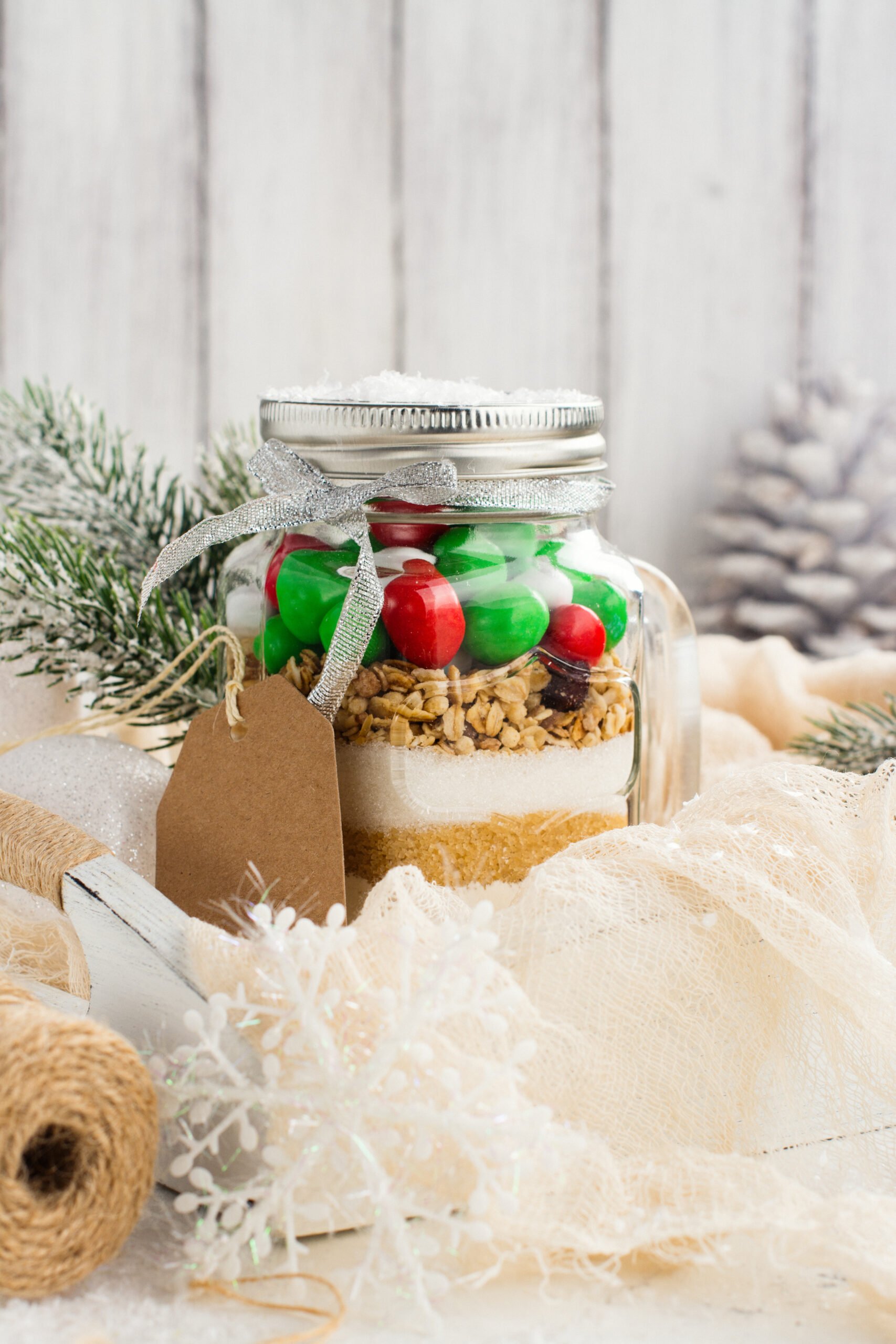 Homemade gift idea; cookie mix in a jar! A mason jar filled with pre-measured dry ingredients for delicious and festive Christmas cookies! Cookies mix with color candies in a jar. Handmade Christmas gift. Great gift or stocking stuffer!