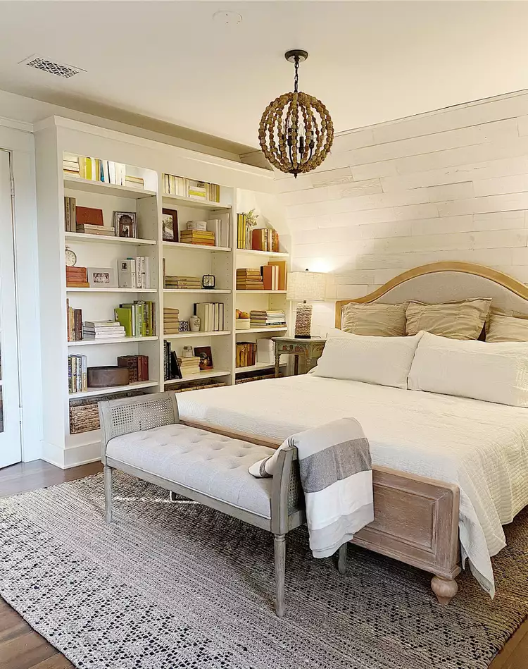 Bedroom with built-in bookshelves home office, neutral bedding, and rustic farmhouse accents
