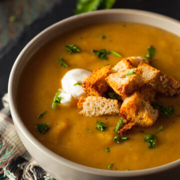 Easy Butternut Squash Soup Recipe; this creamy soup recipe is perfect for any cold day! Vegan and dairy free! Serve with bread for the ultimate experience.