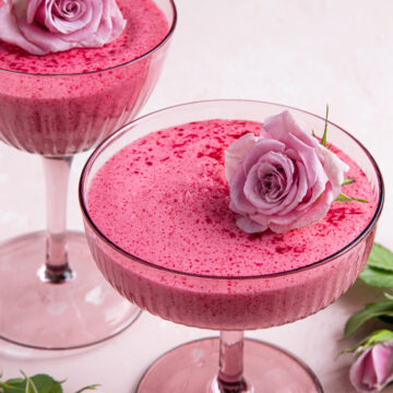 Pink Berry Mousse Recipe; an easy pink dessert recipe that is fluffy and melts in your mouth! Perfect for Valentine's day! {delicious berry mousse in glass, festive dessert for Valentines day, pink background, selective focus}