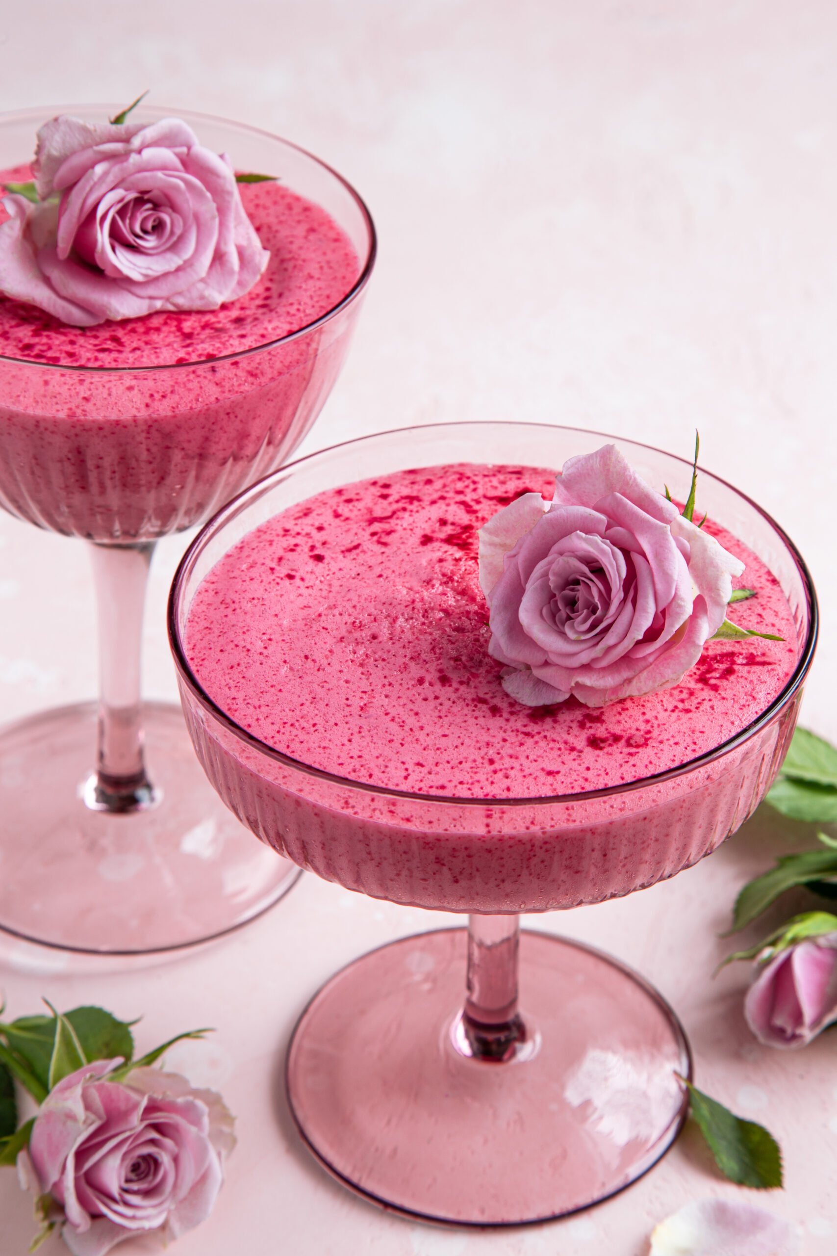 Pink Berry Mousse Recipe; an easy pink dessert recipe that is fluffy and melts in your mouth! Perfect for Valentine's day! {delicious berry mousse in glass, festive dessert for Valentines day, pink background, selective focus}