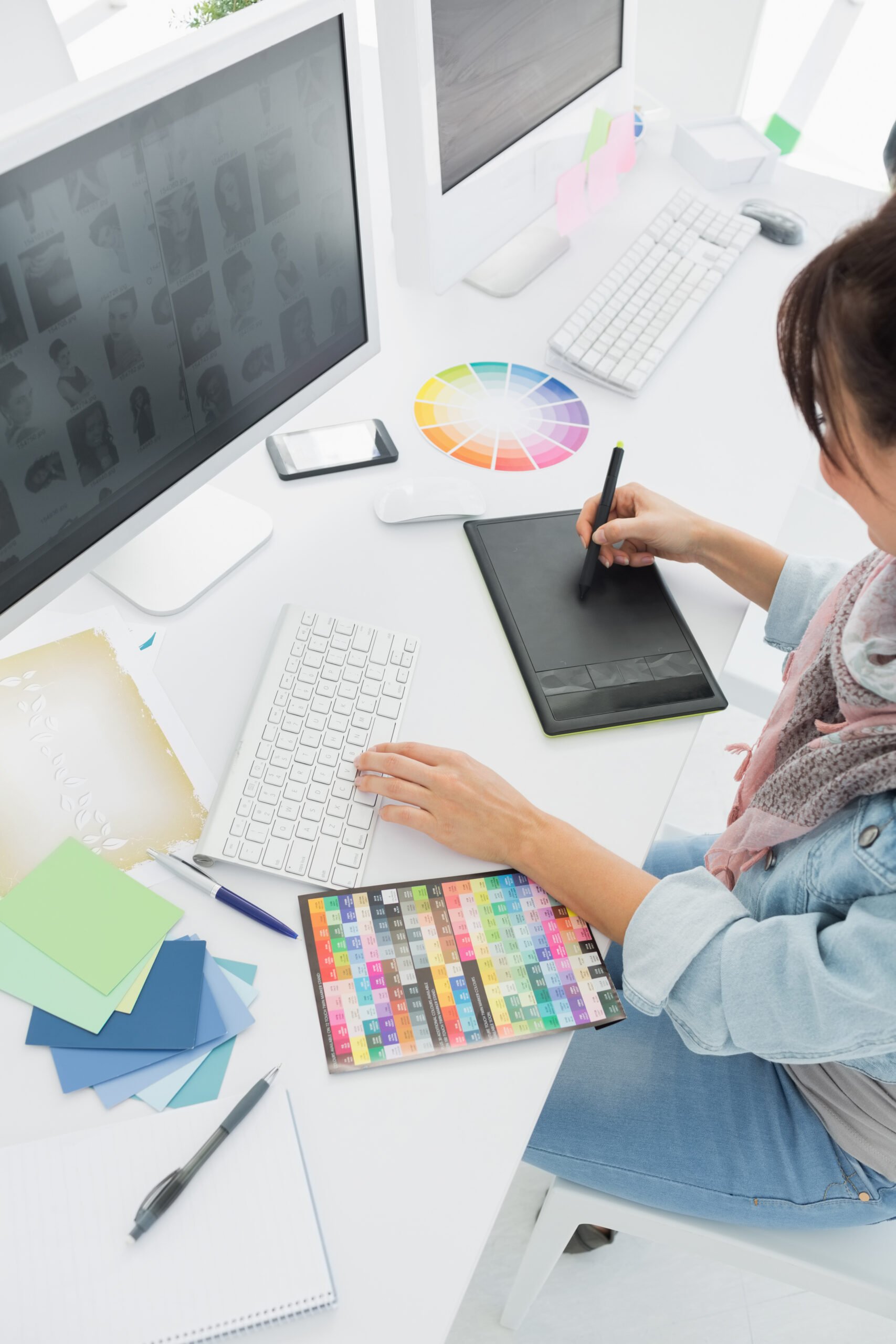 High angle view of an artist drawing something on graphic tablet at the office - Branding is an essential part of any business strategy. Each viable strategy for branding, has its own set of advantages and challenges.