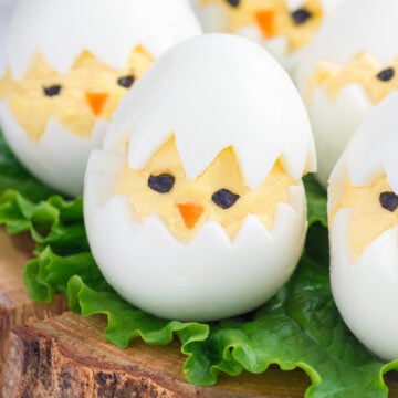 Easy Easter Deviled Eggs Recipe; A dozen eggs with a hard-boiled center and a creamy yellow yolk made to look like chicks for a perfect Easter appetizer.