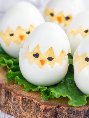 Easy Easter Deviled Eggs Recipe; A dozen eggs with a hard-boiled center and a creamy yellow yolk made to look like chicks for a perfect Easter appetizer.