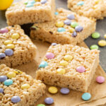 Mini Egg Rice Krispie Squares Recipe; Made with crispy rice cereal, marshmallows, Cadbury mini eggs. These mini egg rice krispie treats are a fun and easy Easter dessert perfect to share with friends or family.