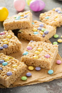 Mini Egg Rice Krispie Squares Recipe; Made with crispy rice cereal, marshmallows, Cadbury mini eggs. These mini egg rice krispie treats are a fun and easy Easter dessert perfect to share with friends or family.