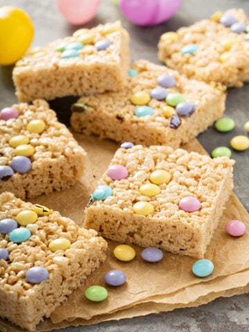 Mini Egg Rice Krispie Squares Recipe; Made with crispy rice cereal, marshmallows, Cadbury mini eggs. These mini egg rice krispie treats are a fun and easy Easter dessert perfect to share with friends or family.