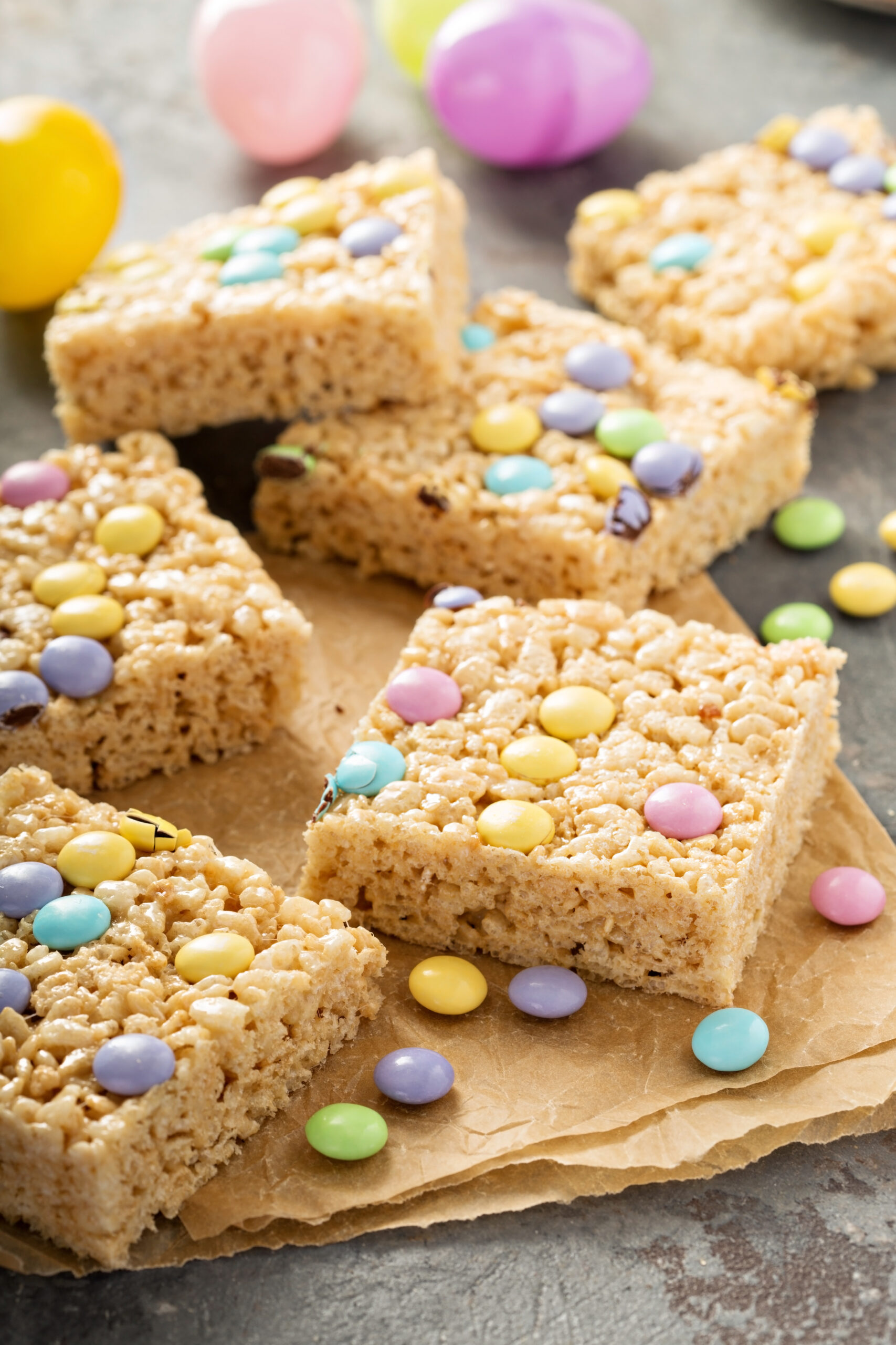 Mini Egg Rice Krispie Squares Recipe; Made with crispy rice cereal, marshmallows, Cadbury mini eggs. These mini egg rice krispie treats are a fun and easy Easter dessert perfect to share with friends or family.