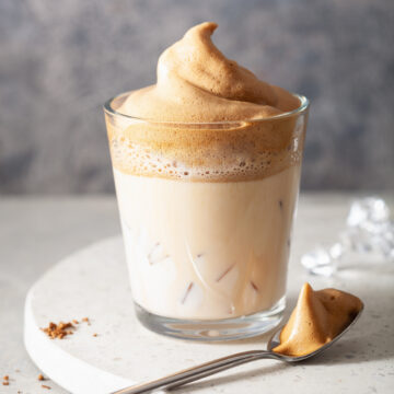 Indulge in the ultimate coffee experience with my easy instant whipped coffee recipe. With just a few ingredients and a whisk, you can create a frothy and creamy coffee treat that will satisfy your caffeine cravings. Perfect for coffee lovers on the go! dalgona coffee in glass. trendy Instant coffee whipped with sugar and hot water