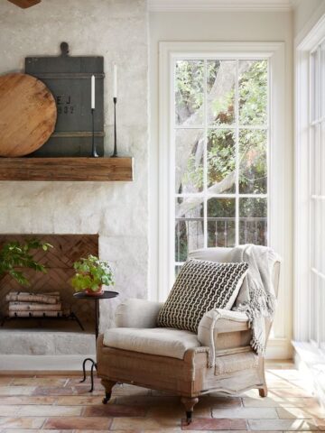 European Cottage Interiors - white Living room with white stone fireplace and big windows