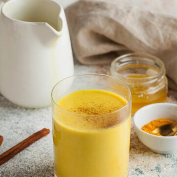 Looking for a warm and healthy drink? Try this Turmeric Latte Recipe made with fragrant spices and your choice of milk. This easy and delicious recipe is packed with the health benefits of turmeric, ginger, and cinnamon. Moon milk for better sleep. Turmeric Golden milk with cinnamon, honey. A trendy relaxing drink before going to bed. Ayurvedic drink. High quality photo