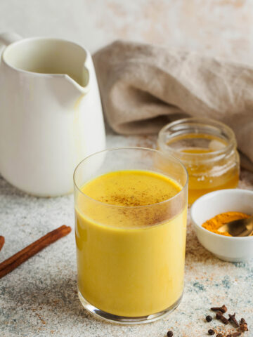 Looking for a warm and healthy drink? Try this Turmeric Latte Recipe made with fragrant spices and your choice of milk. This easy and delicious recipe is packed with the health benefits of turmeric, ginger, and cinnamon. Moon milk for better sleep. Turmeric Golden milk with cinnamon, honey. A trendy relaxing drink before going to bed. Ayurvedic drink. High quality photo