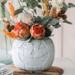 Halloween Pumpkin Decor Ideas: Turn your pumpkins into planters by hollowing them out and filling them with your favorite fall flowers or plants. This is a great way to bring some life to your Halloween decor. Opt for brightly colored flowers, such as orange marigolds or purple pansies, to complement the pumpkin's natural hue.