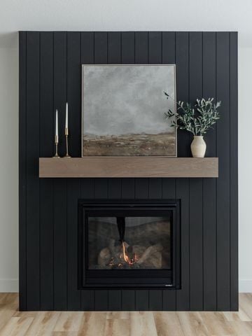 15 Black Shiplap Fireplace Ideas for a Moody Vibe; A stylish black shiplap fireplace adding a modern and elegant touch to the room.