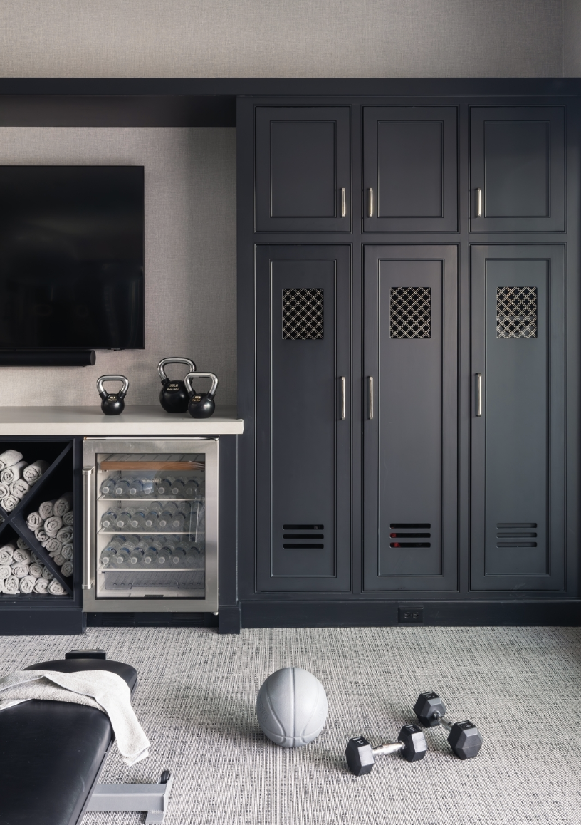Modern basement home gym featuring custom built-in storage, sleek cabinetry, and wellness-focused design elements, showcasing basement trends for 2026