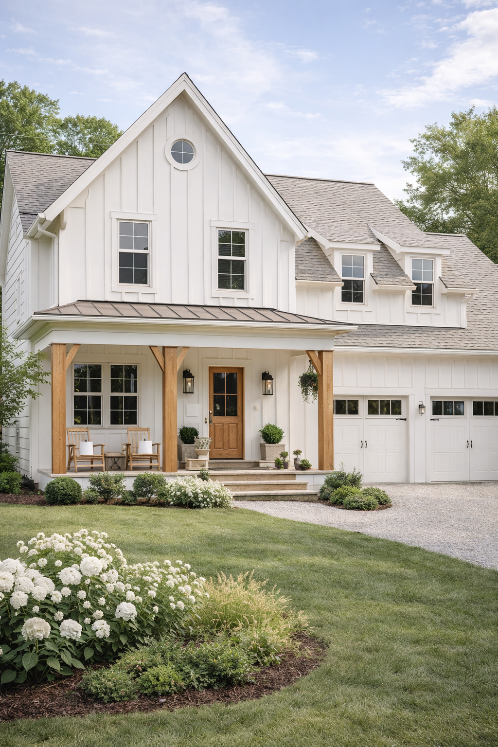 Light-colored modern farmhouse exterior with white siding, natural wood porch columns, black windows, and soft landscaping inspired by modern farmhouse trends for 2026