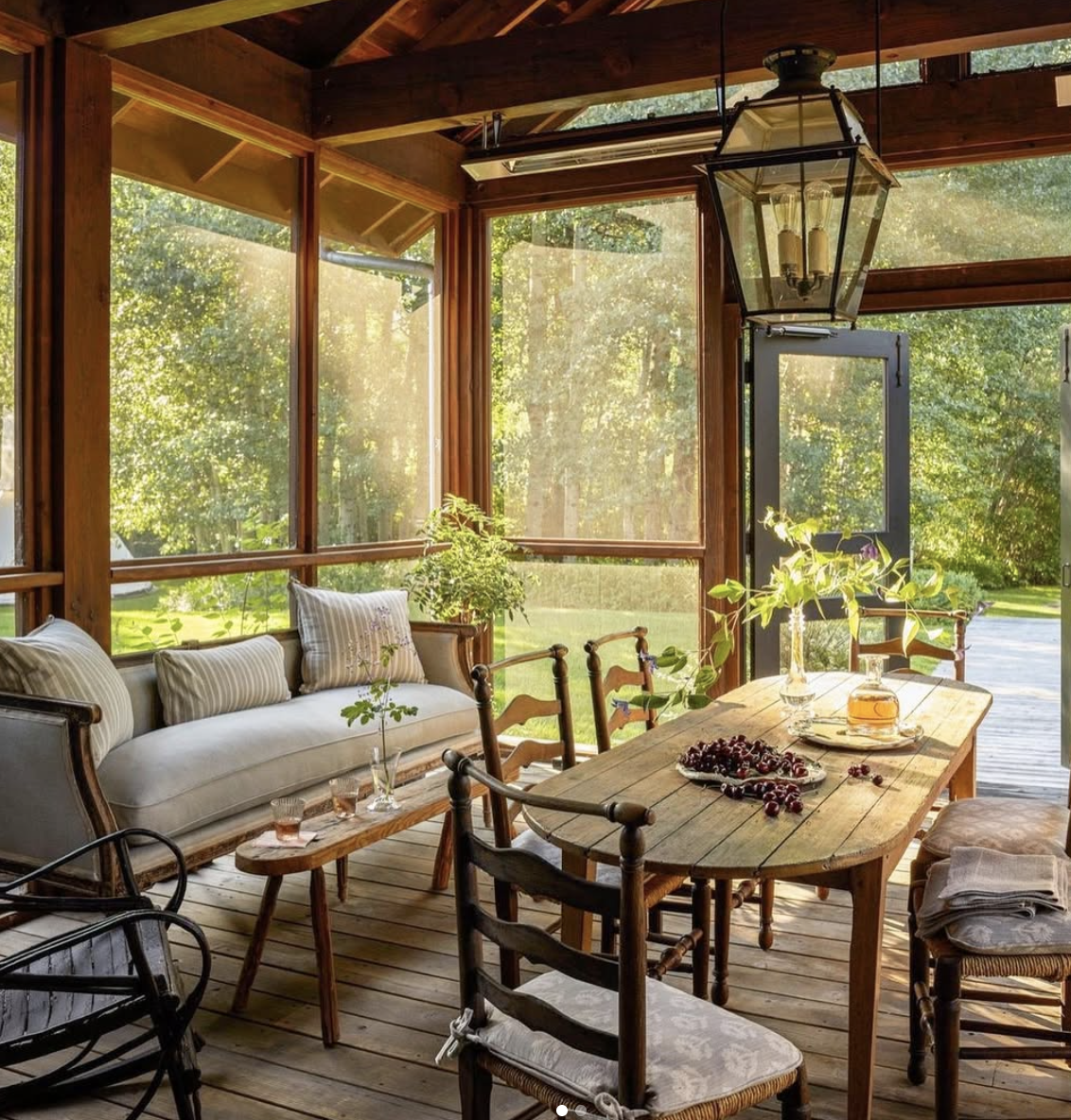 cozy back porch dining area with wooden table and natural light