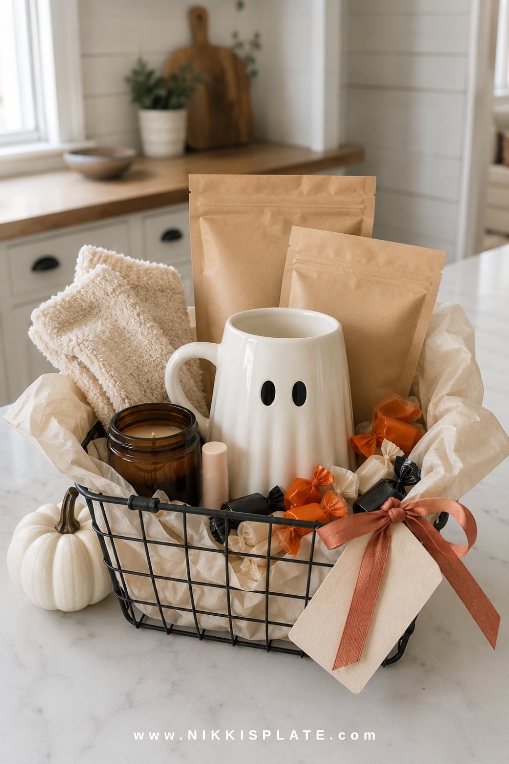 Budget boo basket under $25 with a ghost mug, hot cocoa, candy, fuzzy socks, lip balm and a small candle.