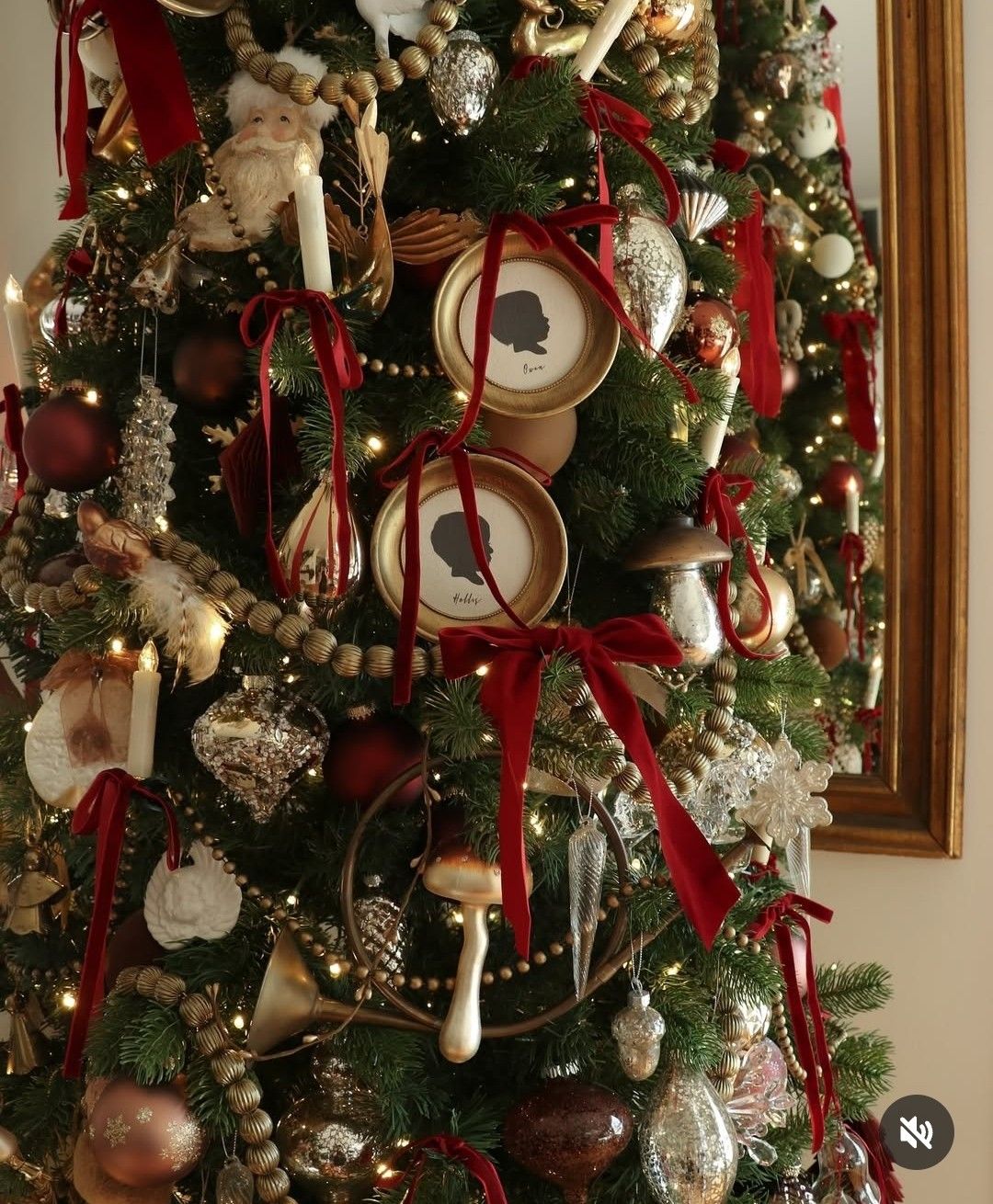 Christmas tree decorated with red velvet ribbons, gold frames, and vintage ornaments for elegant holiday decor.