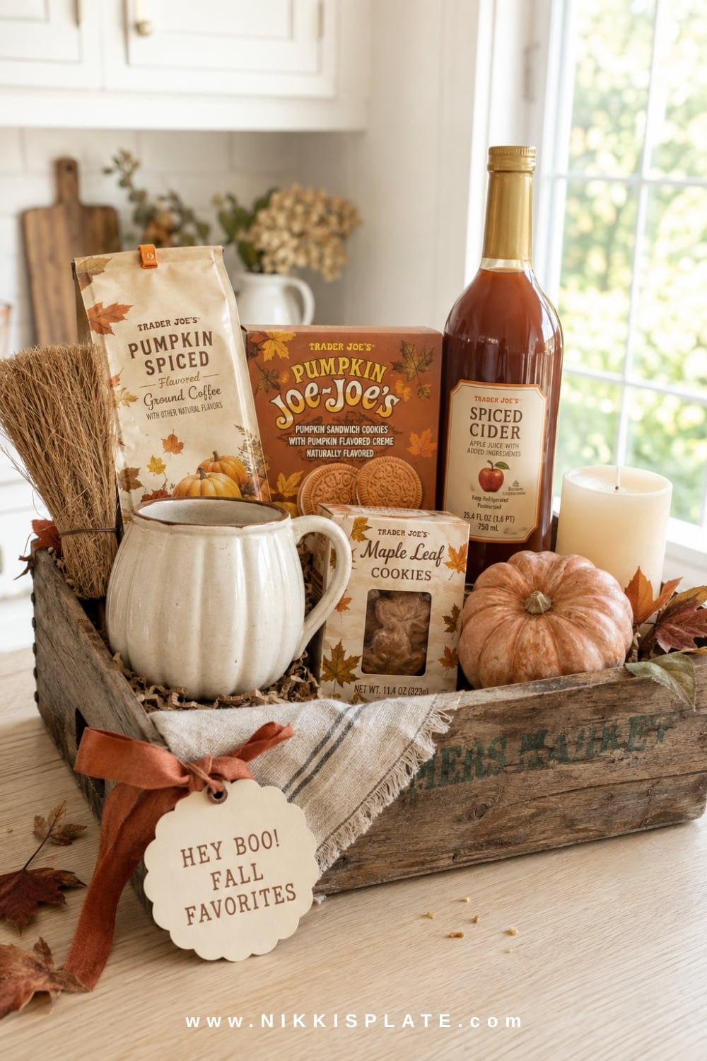 Trader Joe's fall boo basket with pumpkin coffee, seasonal cookies, spiced cider and a cream pumpkin mug.