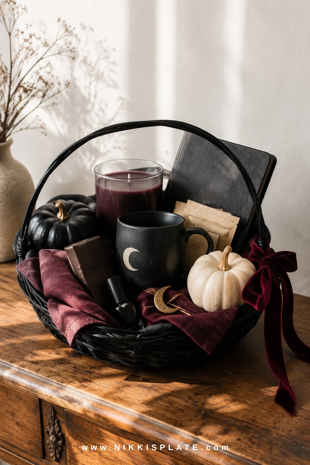 Witchy gothic boo basket with a black candle, dark chocolate, celestial mug, journal, tea and velvet ribbon.