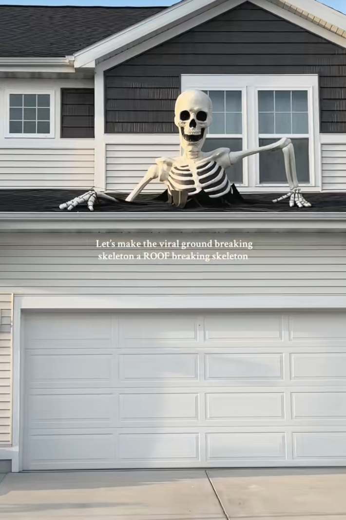 Giant skeleton breaking through roof above garage - unique skeleton ideas for Halloween