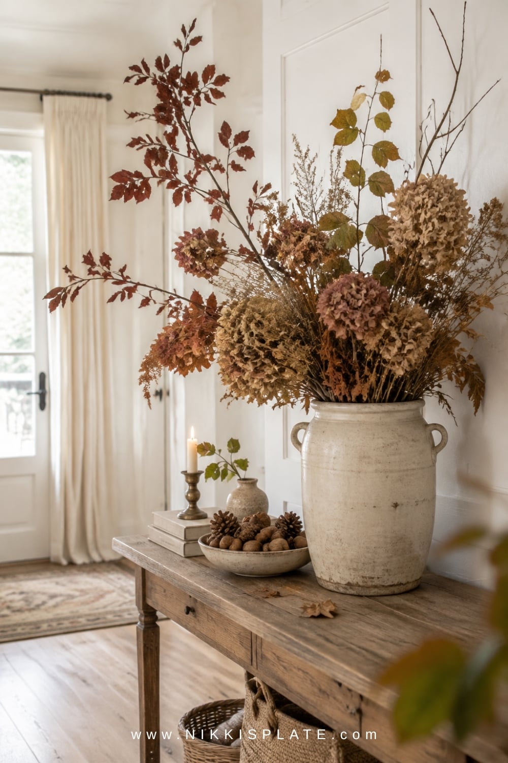 Natural fall entryway arrangement with foraged branches displayed in a rustic ceramic vase